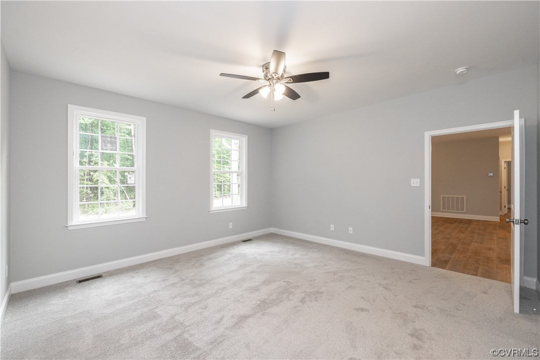 76 Trents Mill Road Cumberland, VA 23040 - Photo 15 of 36 an empty room with windows and fan
