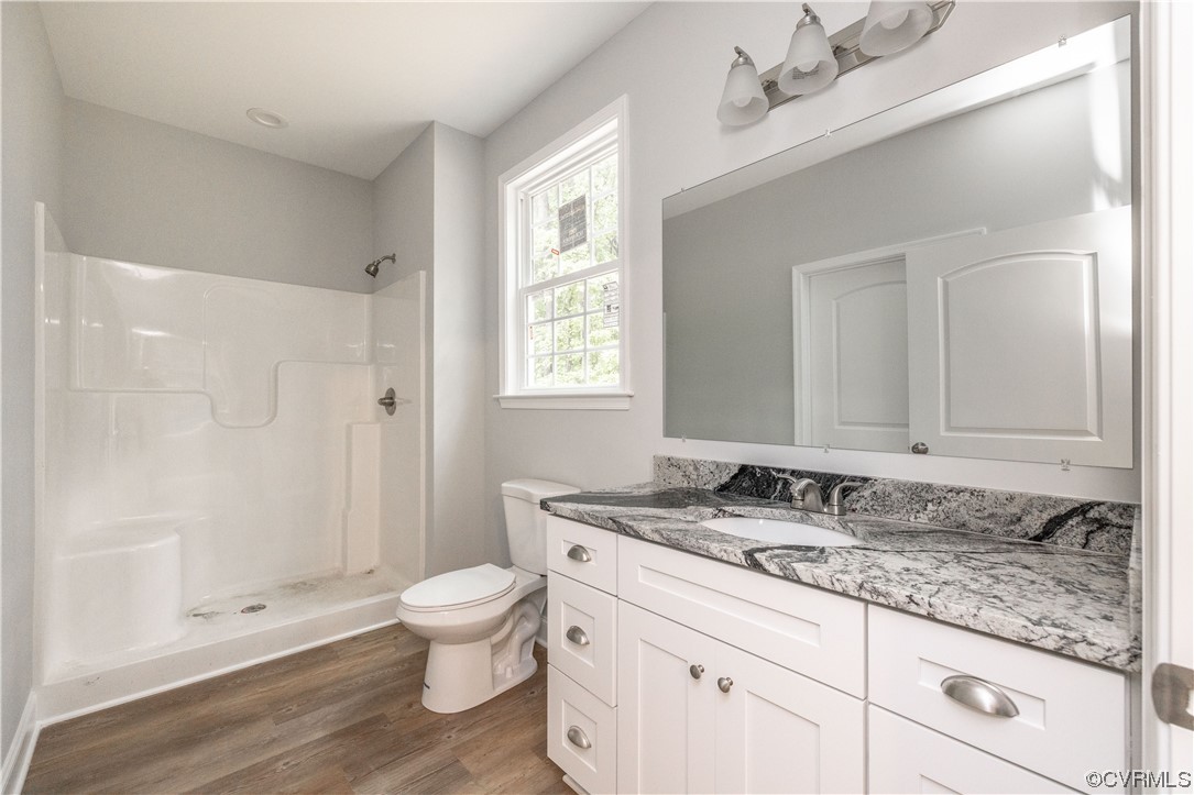 76 Trents Mill Road Cumberland, VA 23040 - Photo 17 of 36 a bathroom with a granite countertop sink a toilet a large mirror and shower