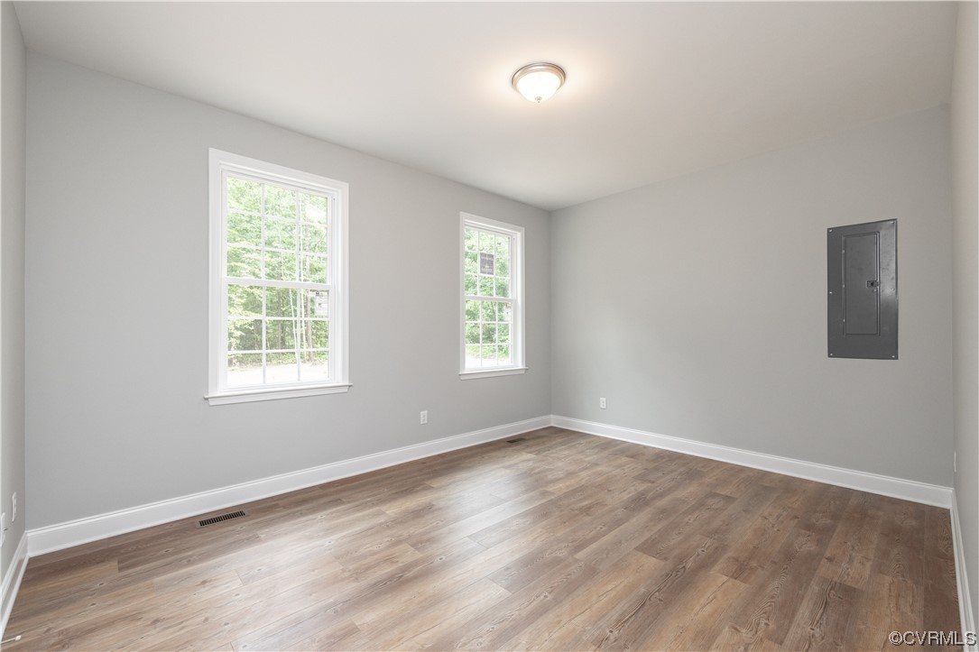 76 Trents Mill Road Cumberland, VA 23040 - Photo 26 of 36 an empty room with wooden floor and windows