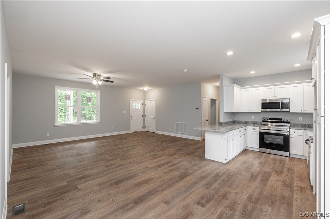 76 Trents Mill Road Cumberland, VA 23040 - Photo 4 of 36 a kitchen with stainless steel appliances kitchen island granite countertop a stove a sink and a refrigerator