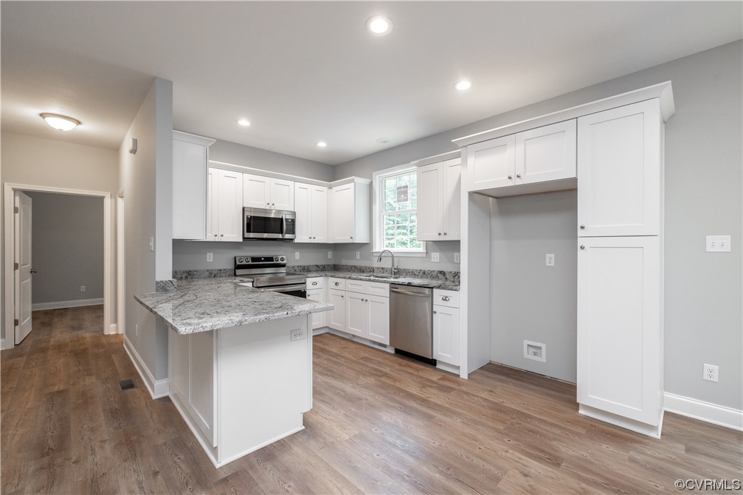 76 Trents Mill Road Cumberland, VA 23040 - Photo 7 of 36 a kitchen with stainless steel appliances granite countertop a stove top oven a sink a refrigerator and white cabinets with wooden floor