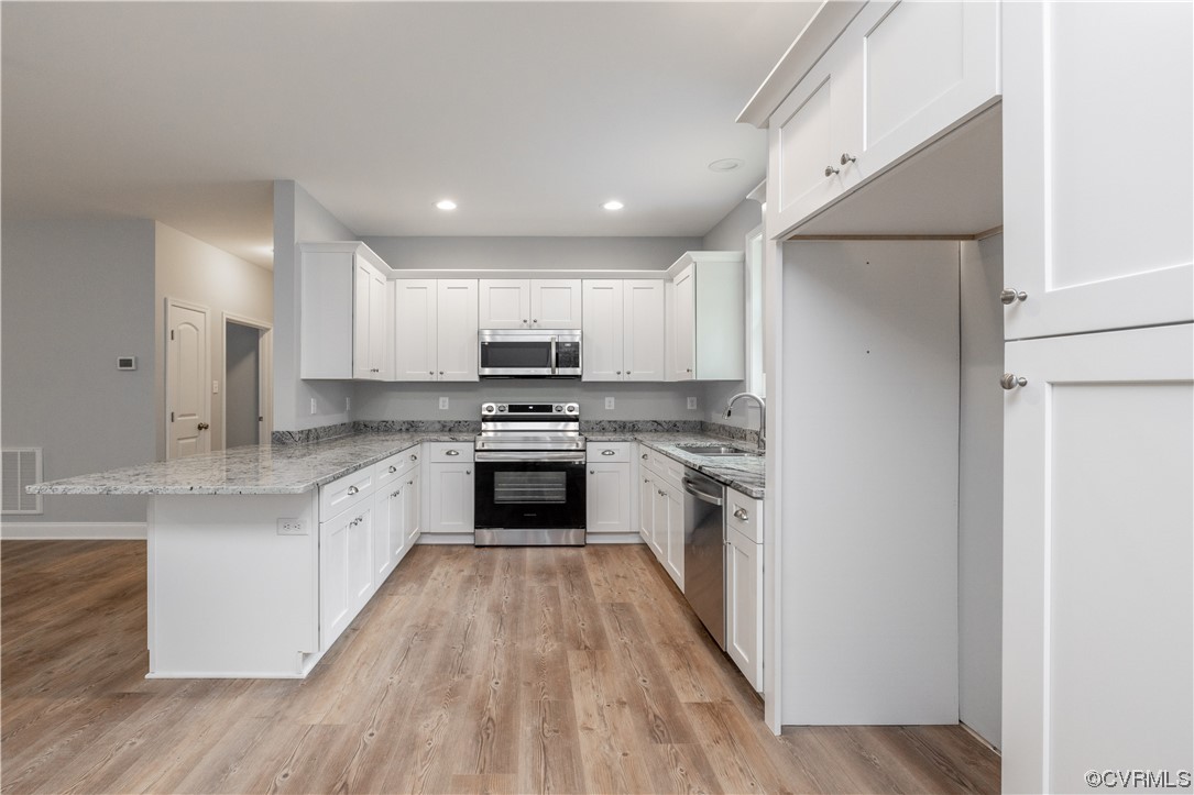 76 Trents Mill Road Cumberland, VA 23040 - Photo 8 of 36 a kitchen with granite countertop a sink cabinets stainless steel appliances and a window