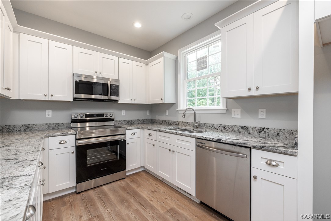 76 Trents Mill Road Cumberland, VA 23040 - Photo 9 of 36 a kitchen with stainless steel appliances granite countertop a stove a sink and a microwave