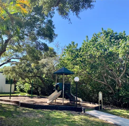 a view of a park with large trees