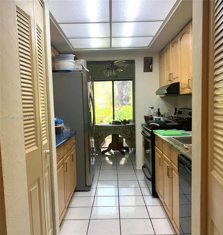 a kitchen with a sink appliances and cabinets