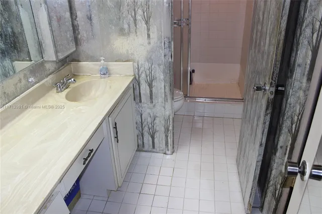 a bathroom with a sink a vanity and shower