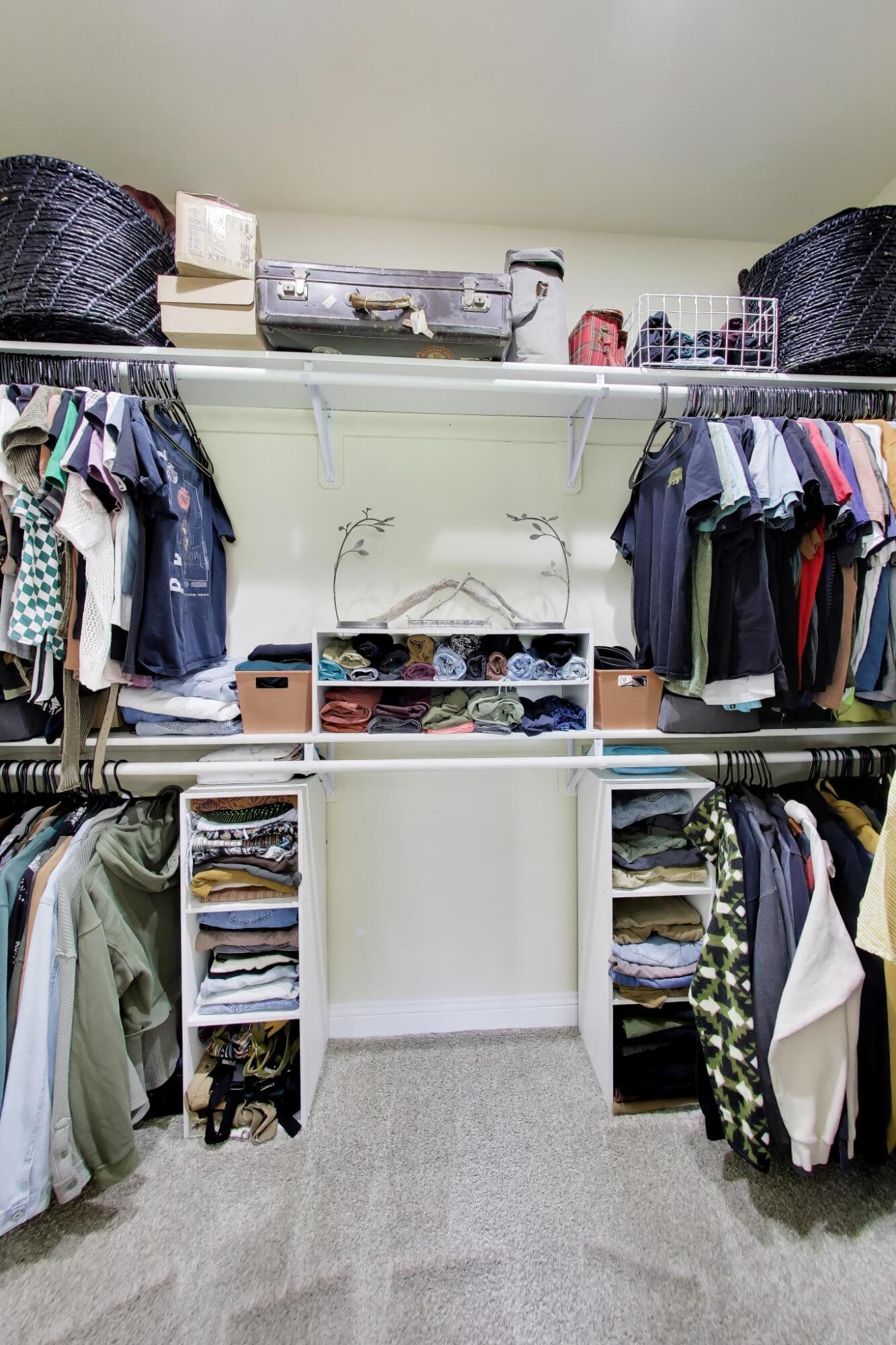 N2392 Mildred Street Delavan, WI 53115 - Photo 11 of 41 Expansive walk-in closet in the primary suite with organized shelving and hanging rods.