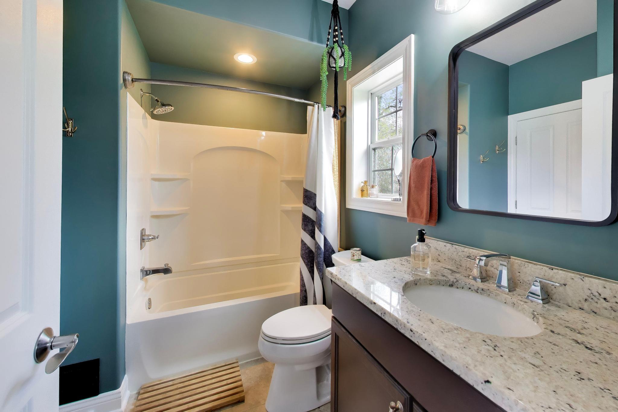 N2392 Mildred Street Delavan, WI 53115 - Photo 12 of 41 Modern bathroom with a granite-topped vanity and a full shower/tub combination.