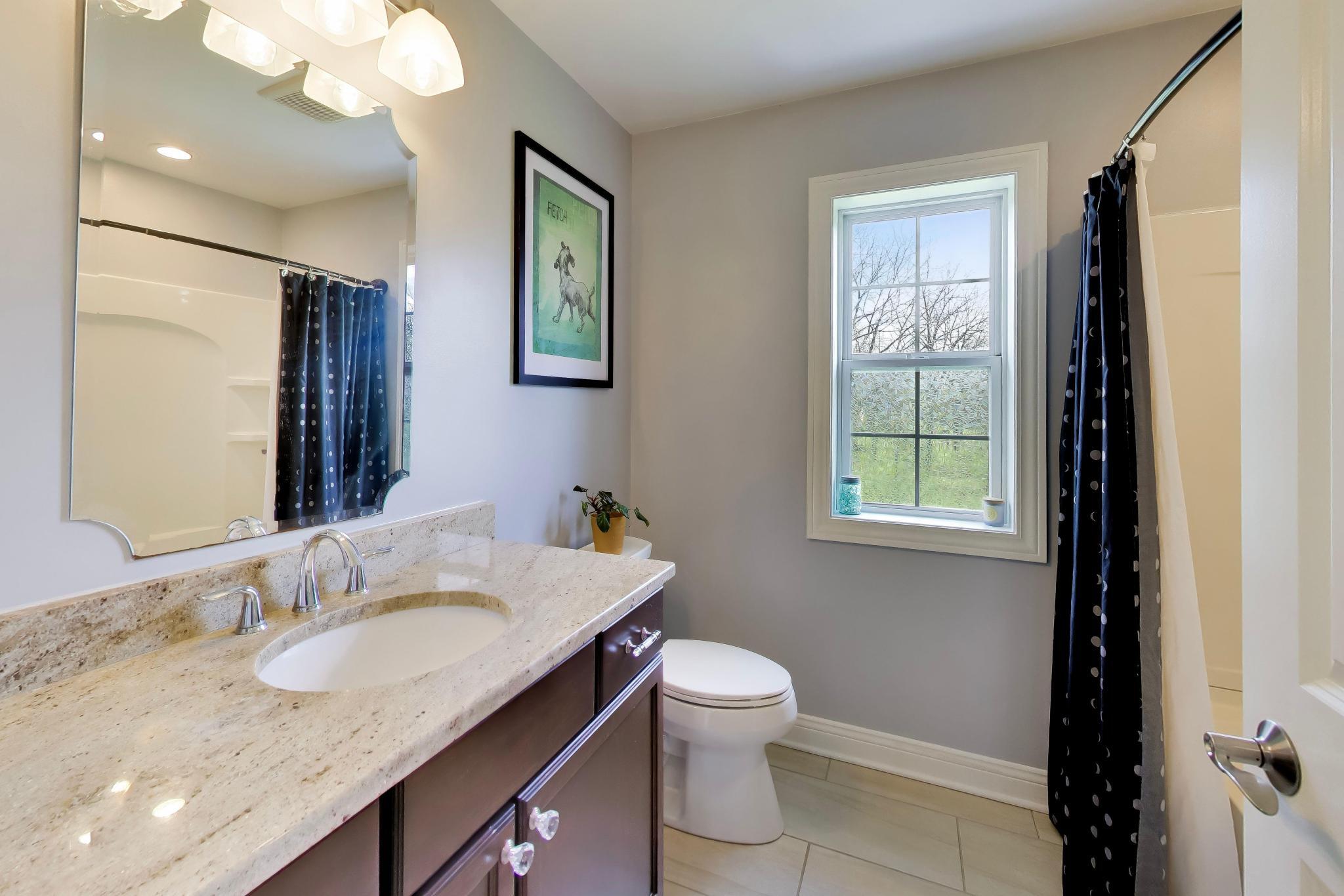 N2392 Mildred Street Delavan, WI 53115 - Photo 21 of 41 Second full bathroom on the upper level featuring a granite vanity and neutral tile flooring.