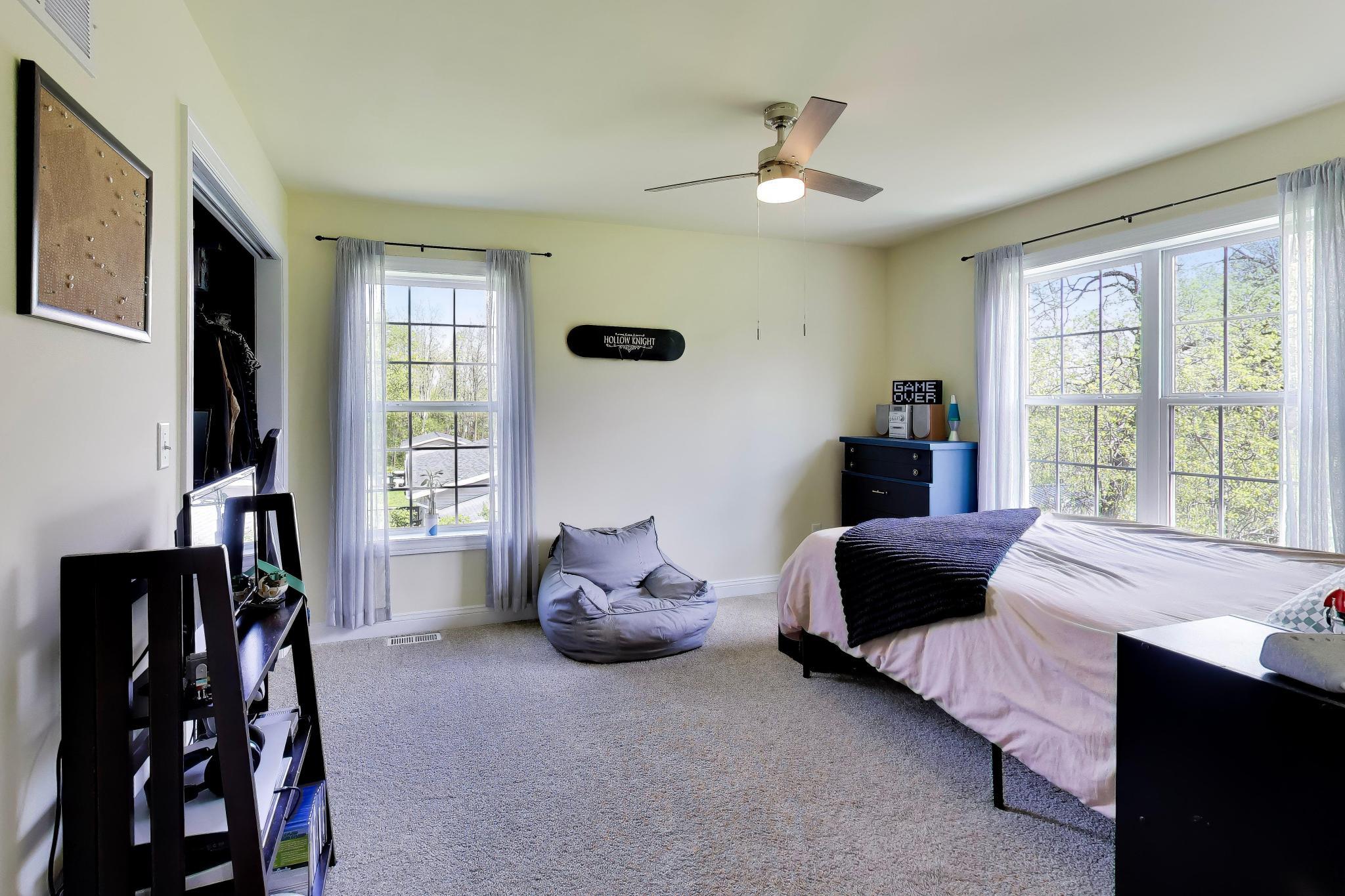 N2392 Mildred Street Delavan, WI 53115 - Photo 24 of 41 Spacious second bedroom located on the upper level with two large windows and a ceiling fan.