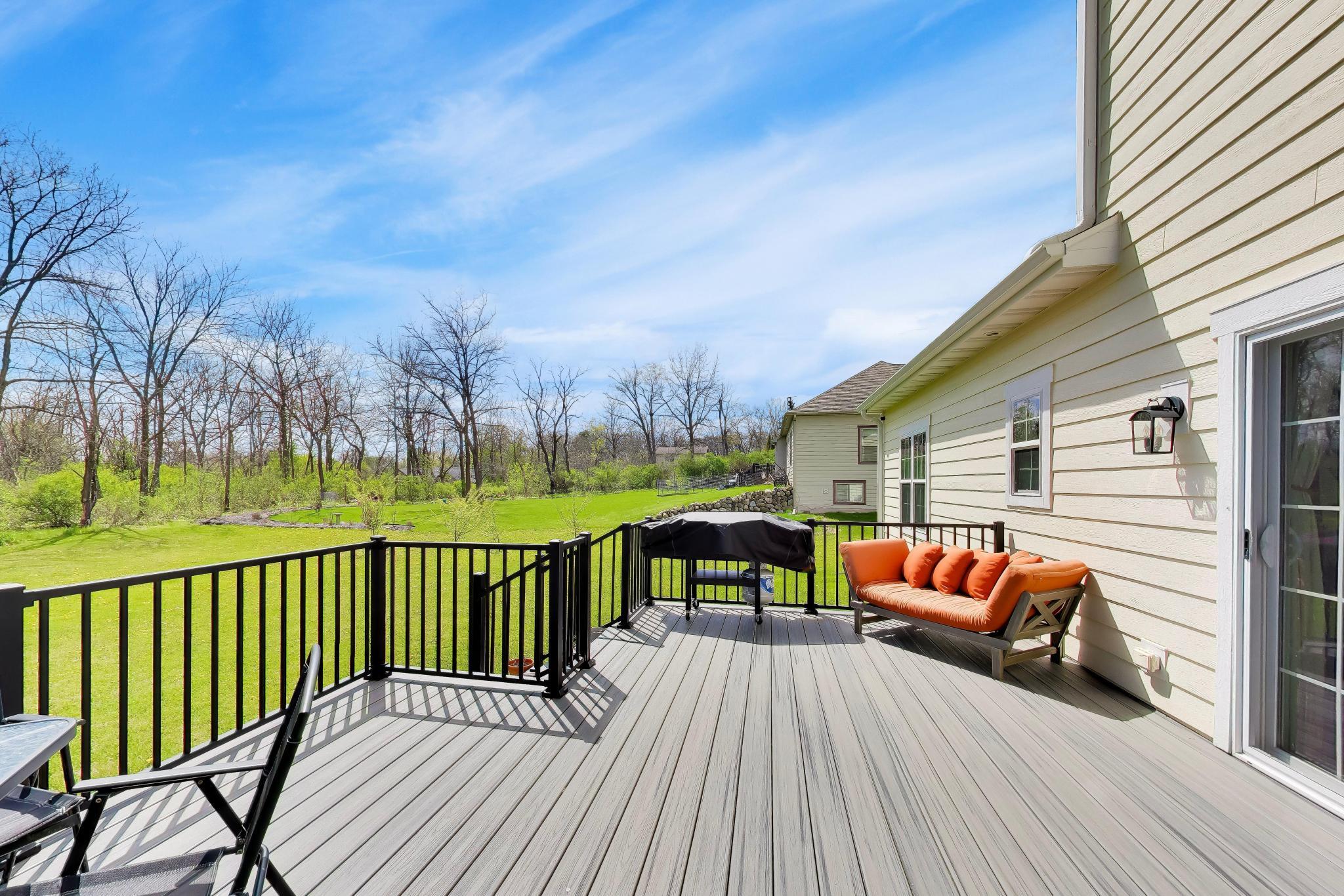 N2392 Mildred Street Delavan, WI 53115 - Photo 27 of 41 Large Trex deck with black railing added in 2021, perfect for outdoor dining and entertaining.