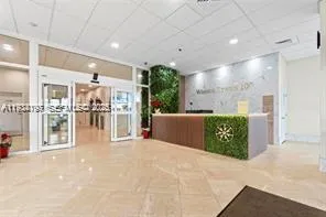 a view of a big room with furniture and a kitchen