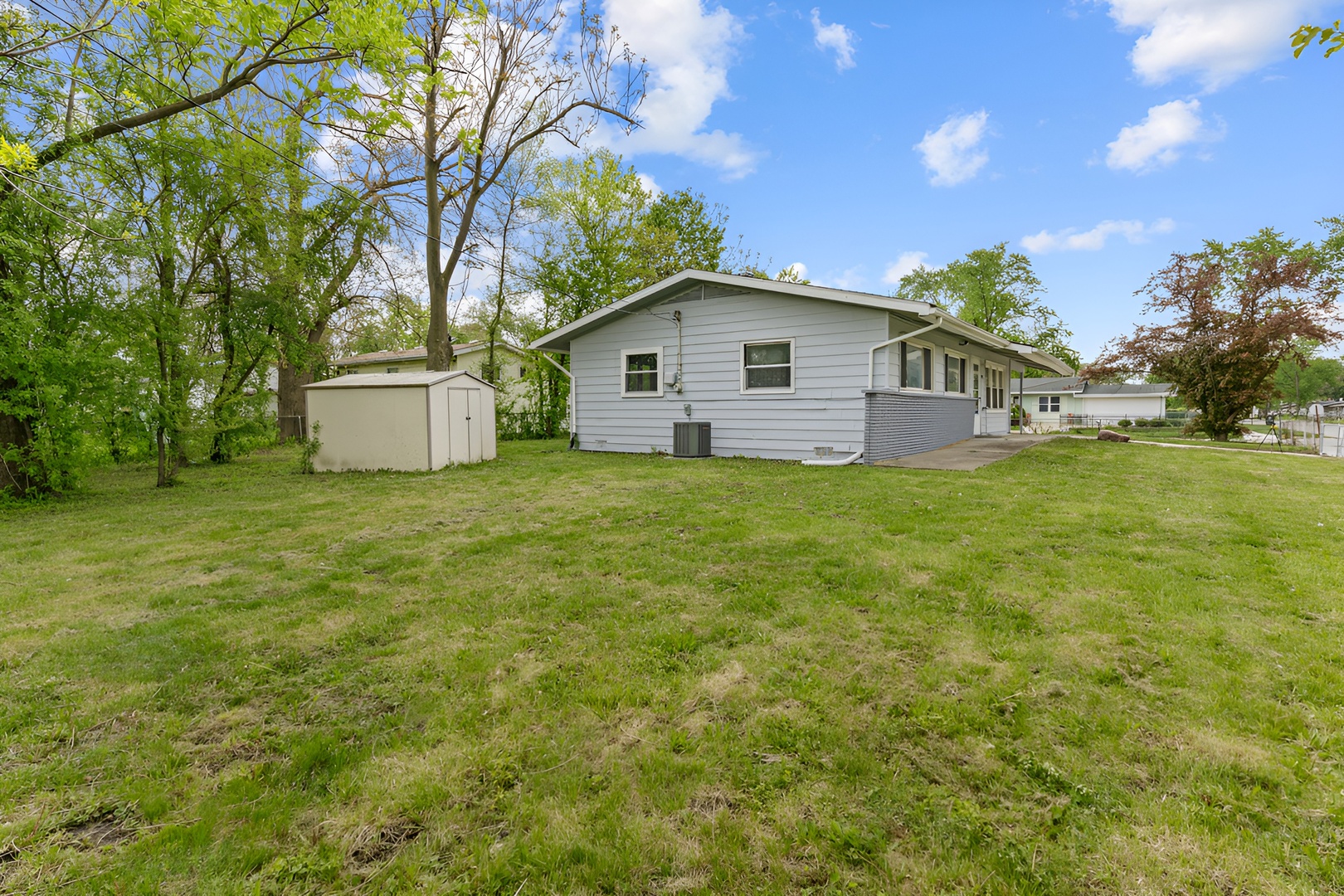 15303 Birch Road Markham, IL 60428 - Photo 20 of 20 a front view of a house with yard and green space