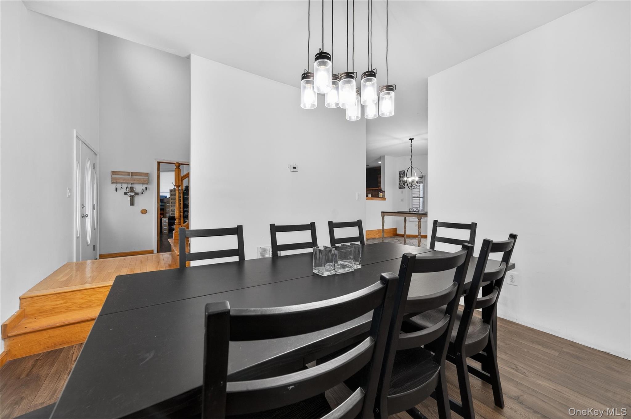 71 Eagle Crest Road Port Jervis, NY 12771 - Photo 13 of 45 Dining area featuring suspended lighting, wood finished floors, and a high ceiling