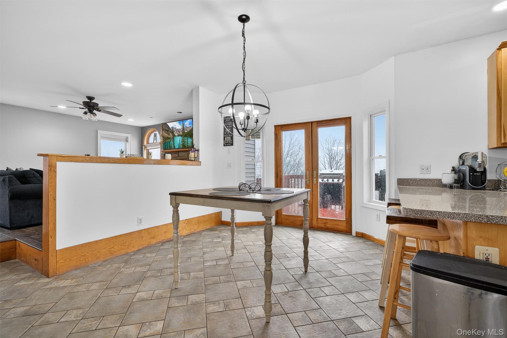 71 Eagle Crest Road Port Jervis, NY 12771 - Photo 14 of 45 Dining space featuring french doors, a ceiling fan, suspended lighting, and light stone finish flooring