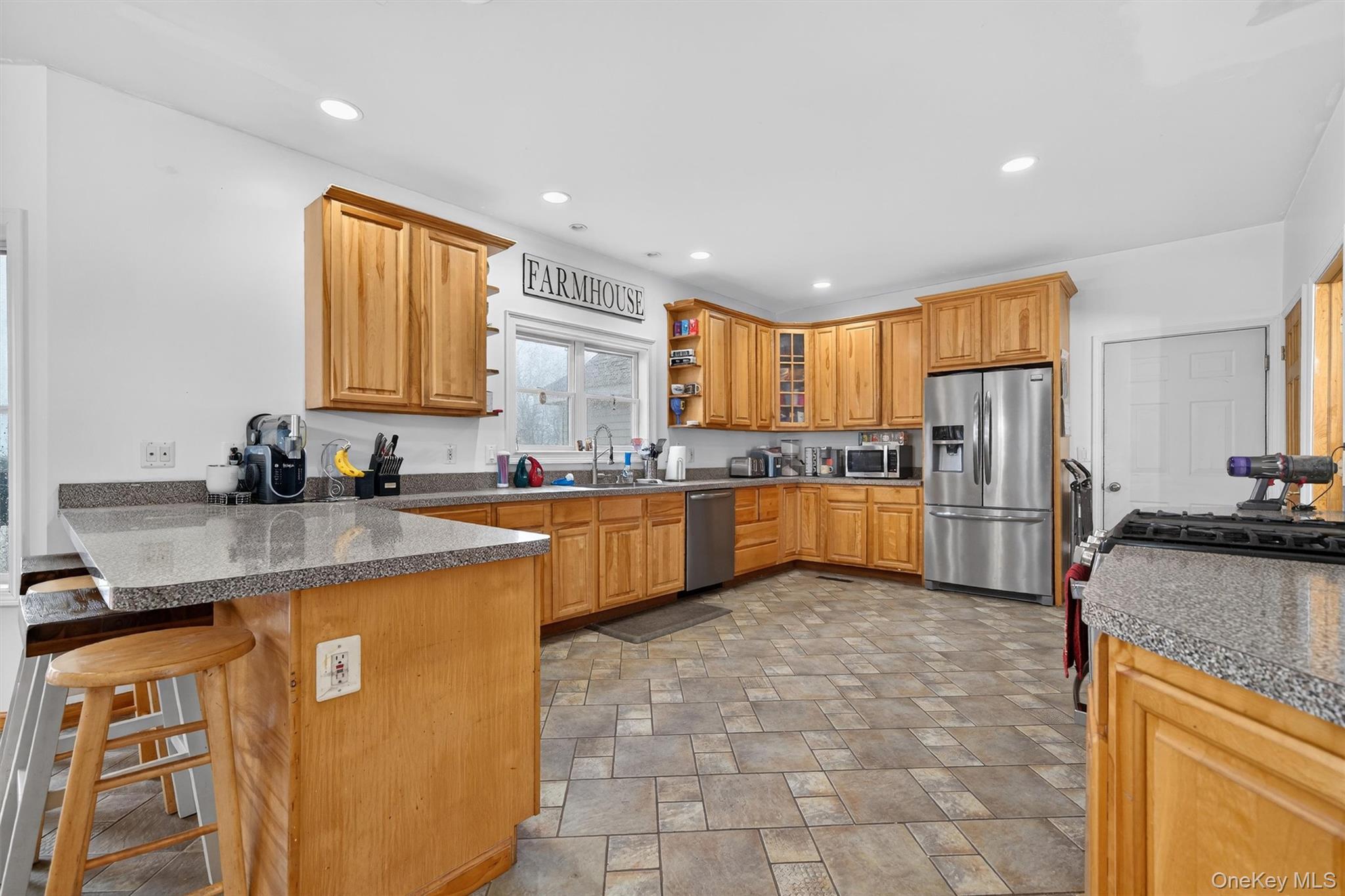71 Eagle Crest Road Port Jervis, NY 12771 - Photo 17 of 45 Kitchen with stainless steel appliances, stone finish flooring, a peninsula, a breakfast bar, and dark countertops