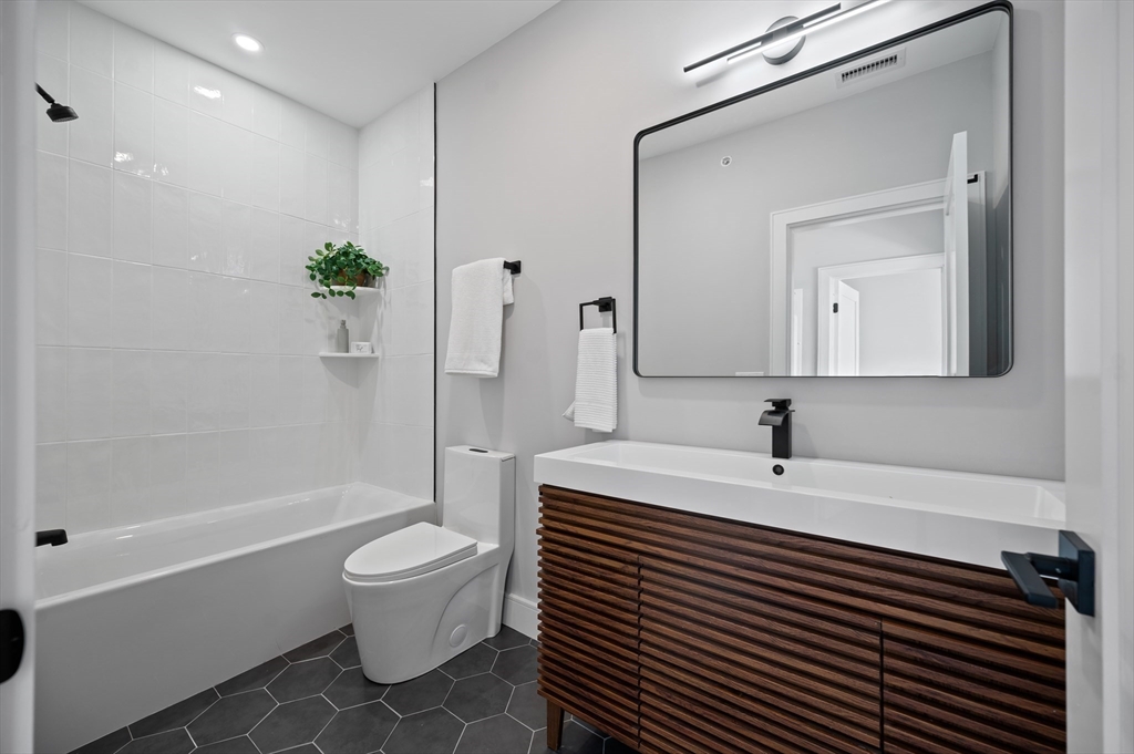 68 Liverpool Street, Unit 3 Boston, MA 02128 - Photo 6 of 6 a bathroom with a toilet a sink and a bathtub