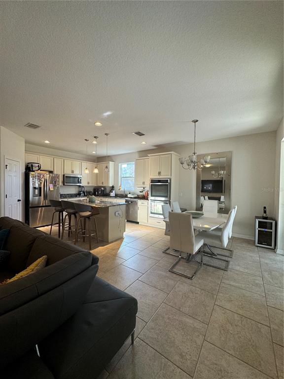 14645 Magnolia Ridge Loop Winter Garden, FL 34787 - Photo 4 of 20 a living room with couches and kitchen view with wooden floor