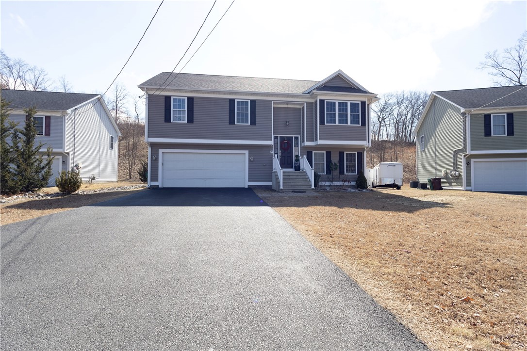 32 Dike Street Woonsocket, RI 02895 - Photo 2 of 20 Spacious 2-car oversized garage complemented by a long driveway with ample parking for 6+ cars.