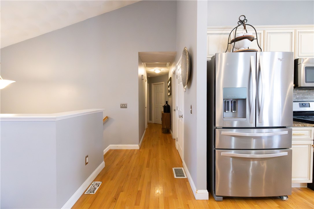 32 Dike Street Woonsocket, RI 02895 - Photo 5 of 20 Gleaming hardwood floors flow throughout the main level, complemented by a stunning vaulted cathedral ceiling.