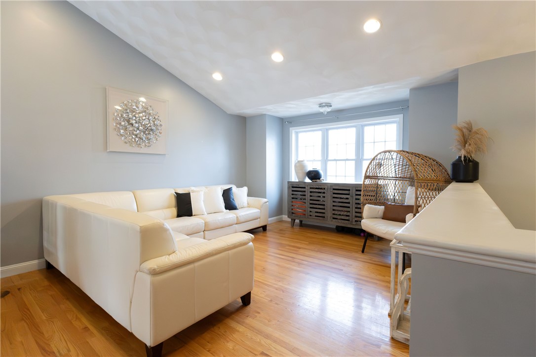 32 Dike Street Woonsocket, RI 02895 - Photo 20 of 20 The open floor plan offers a spacious living room and dining area with double doors leading to a large deck, ideal for indoor-outdoor living.