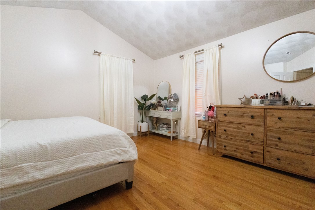 32 Dike Street Woonsocket, RI 02895 - Photo 7 of 20 The primary bedroom boasts a cathedral ceiling, adding elegance and openness.