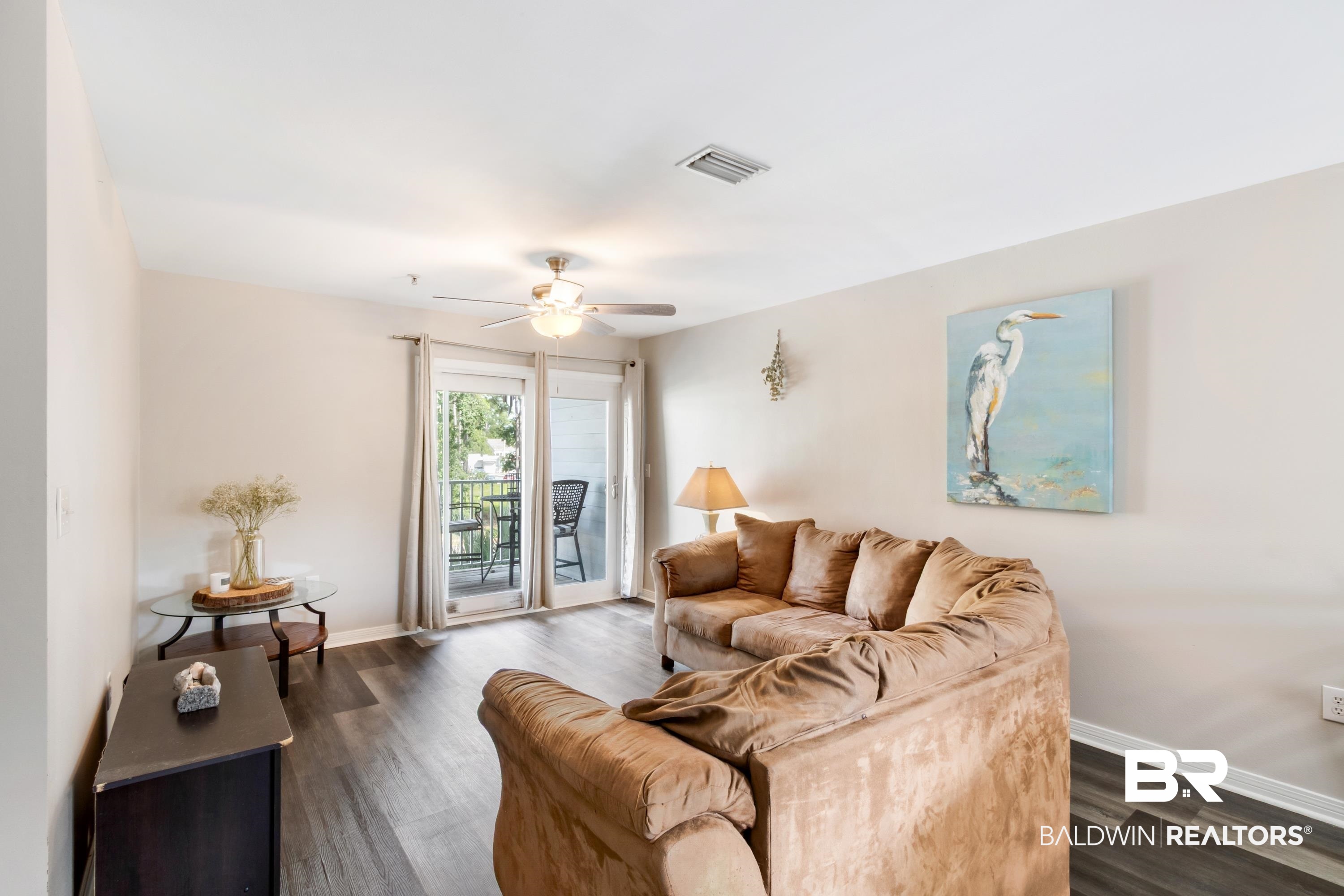 25957 Canal Road, Unit 208 Orange Beach, AL 36561 - Photo 3 of 28 Living area featuring wood-finish flooring, light neutral wall paint, and a ceiling fan with integrated lighting