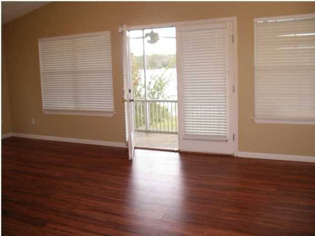 1584 Spring Lake Road DeFuniak Springs, FL 32433 - Photo 5 of 19 a view of an empty room with wooden floor and a window