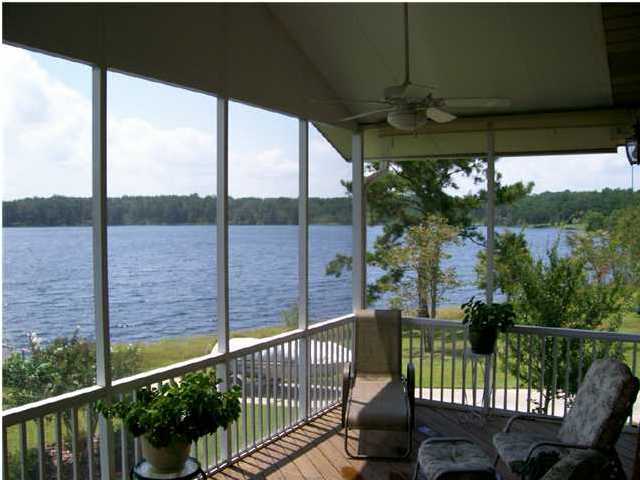 1584 Spring Lake Road DeFuniak Springs, FL 32433 - Photo 10 of 19 a view of a balcony with a floor to ceiling window and wooden fence