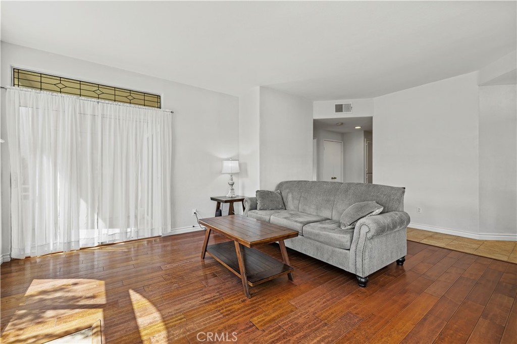 25518 Hemingway Avenue, Unit A Stevenson Ranch, CA 91381 - Photo 12 of 54 a living room with furniture and a wooden floor