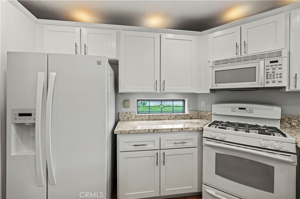 25518 Hemingway Avenue, Unit A Stevenson Ranch, CA 91381 - Photo 18 of 54 a kitchen with granite countertop cabinets and steel stainless steel appliances