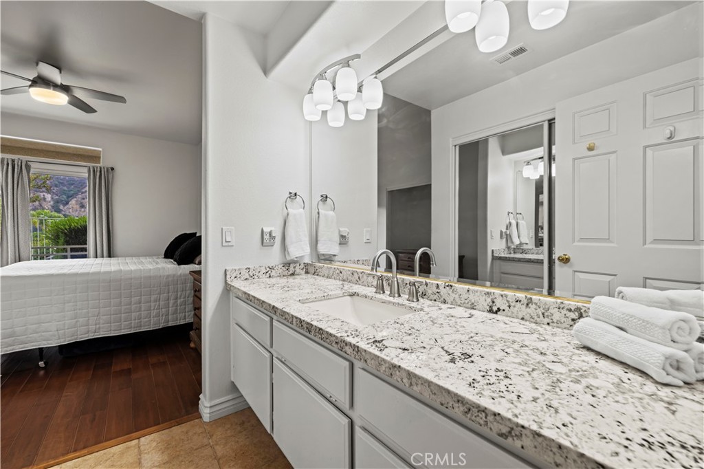 25518 Hemingway Avenue, Unit A Stevenson Ranch, CA 91381 - Photo 27 of 54 a en suite bathroom with a granite countertop sink and a large mirror