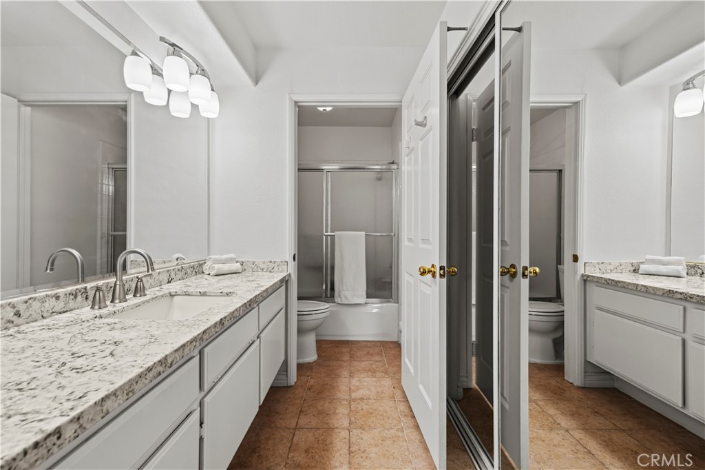 25518 Hemingway Avenue, Unit A Stevenson Ranch, CA 91381 - Photo 28 of 54 a bathroom with a granite countertop sink double and mirror