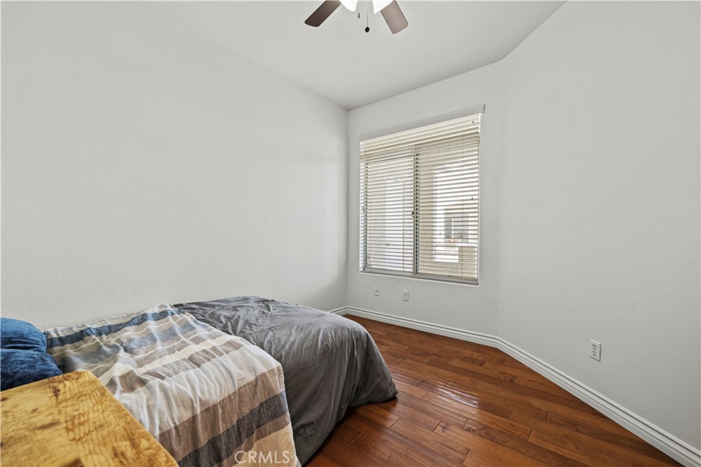 25518 Hemingway Avenue, Unit A Stevenson Ranch, CA 91381 - Photo 33 of 54 a bedroom with a bed and a chandelier fan