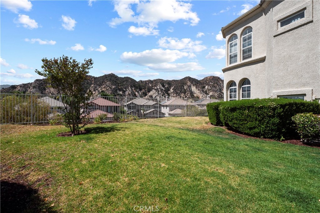 25518 Hemingway Avenue, Unit A Stevenson Ranch, CA 91381 - Photo 45 of 54 a view of an house with backyard and garden