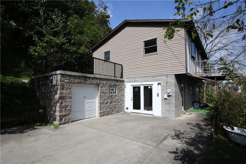 796 Rte 481 Monongahela, PA 15063 - Photo 2 of 26 Side View of Lower-Level Glass French Door Entry into Game Room and small 15x11 Attached Garage w/ Patio above