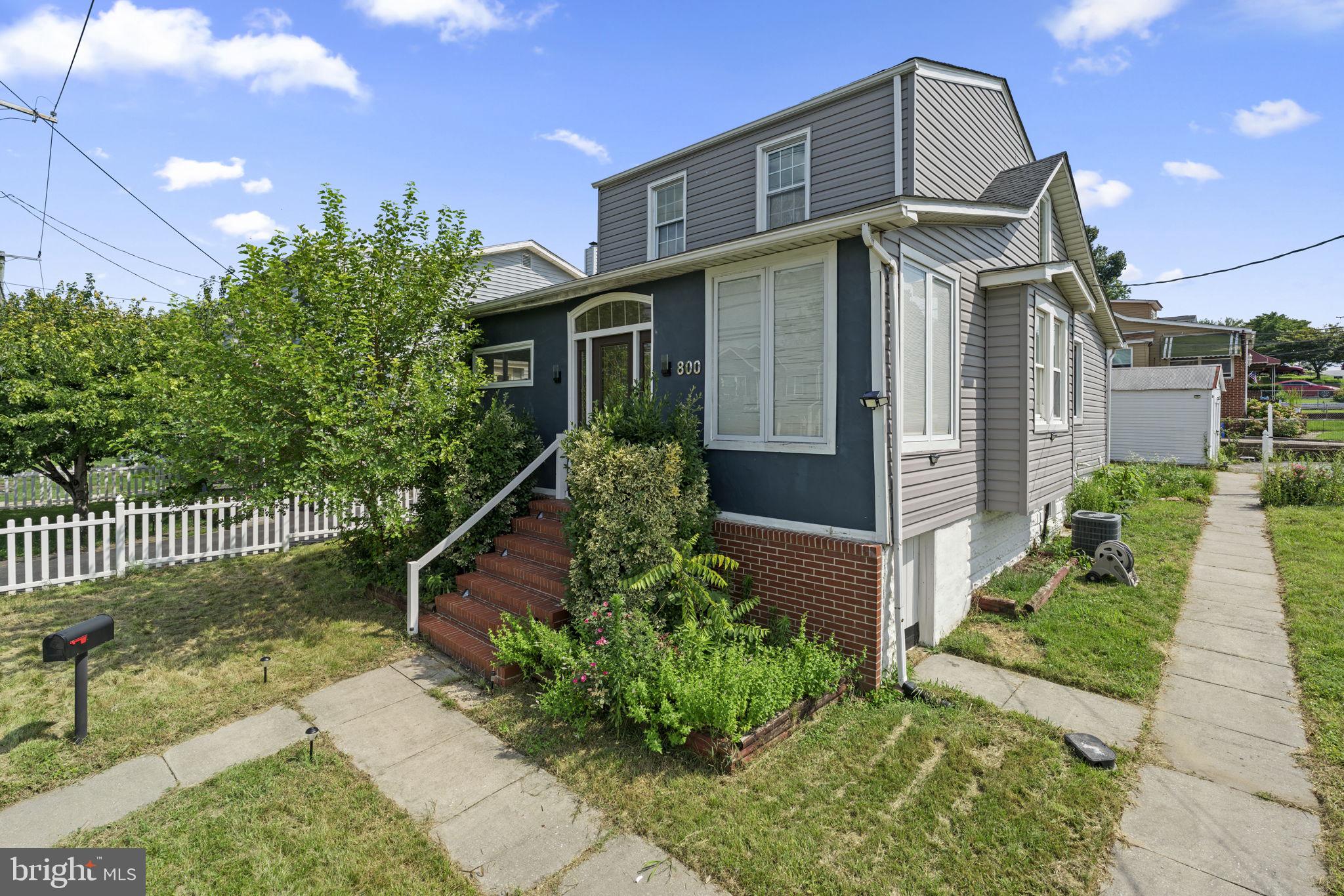 800 North Point Road Baltimore, MD 21224 - Photo 1 of 40 a front view of a house with a garden