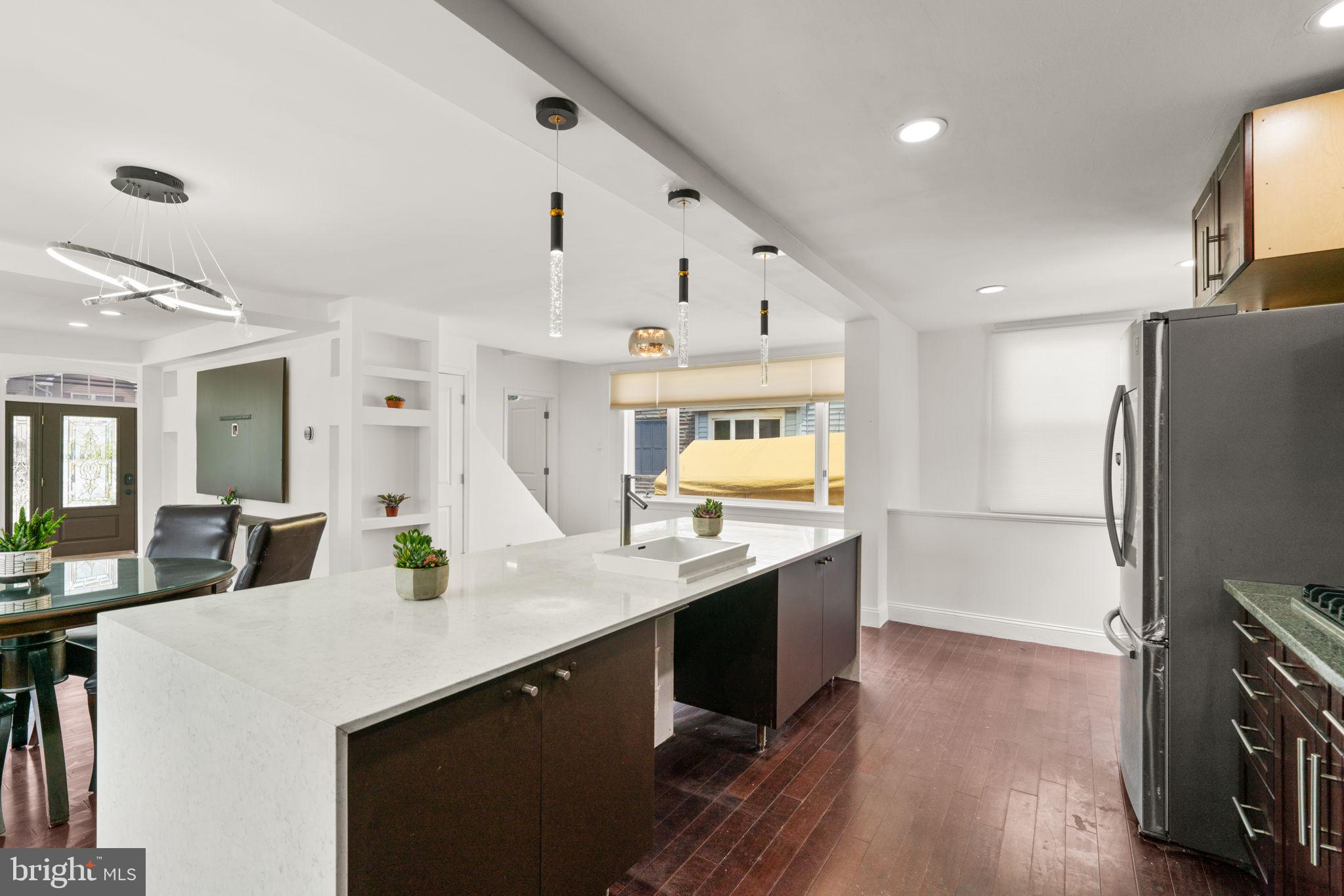 800 North Point Road Baltimore, MD 21224 - Photo 11 of 40 a kitchen with stainless steel appliances granite countertop a sink a stove and a refrigerator