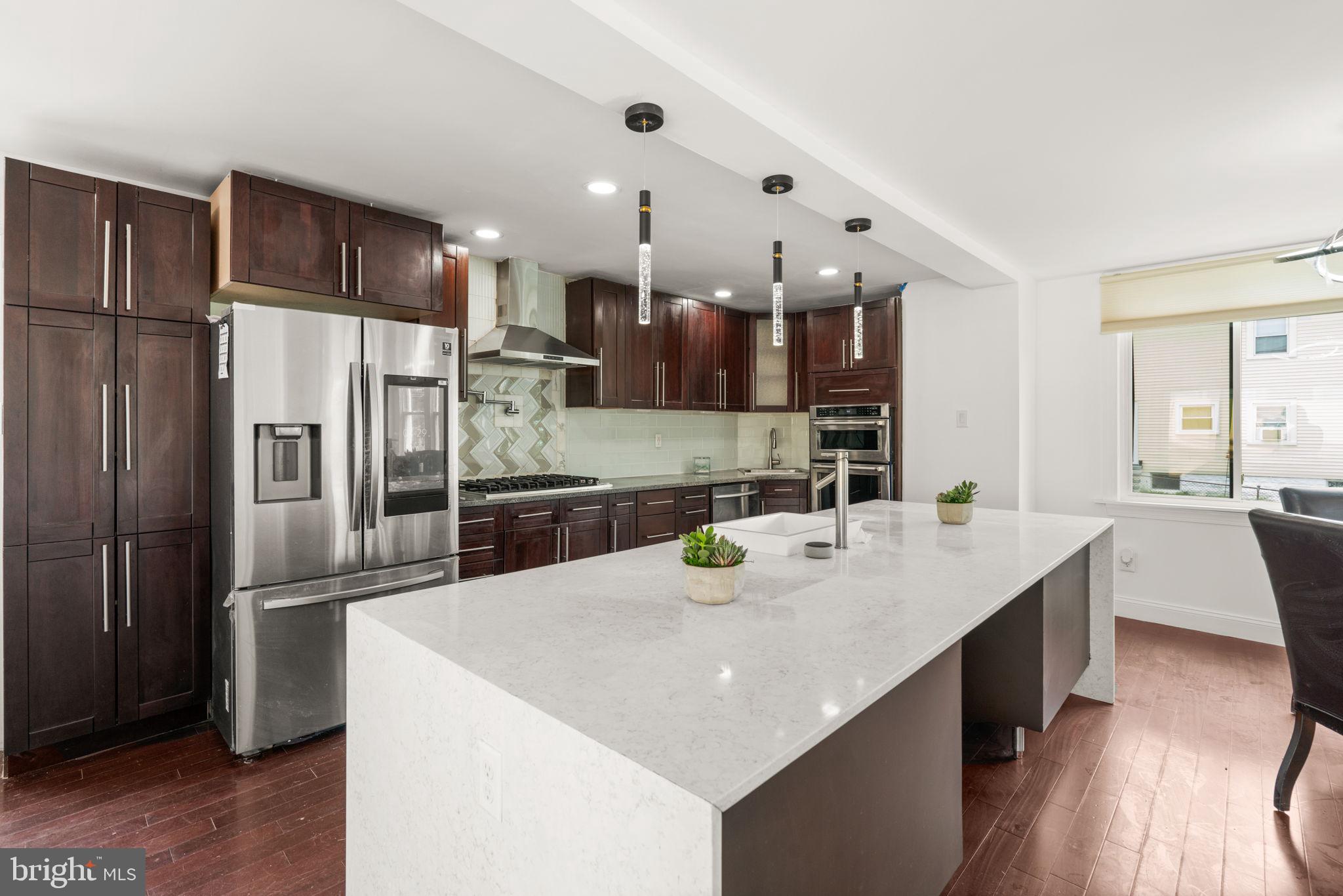 800 North Point Road Baltimore, MD 21224 - Photo 14 of 40 a kitchen with kitchen island a counter top space a sink stainless steel appliances and cabinets