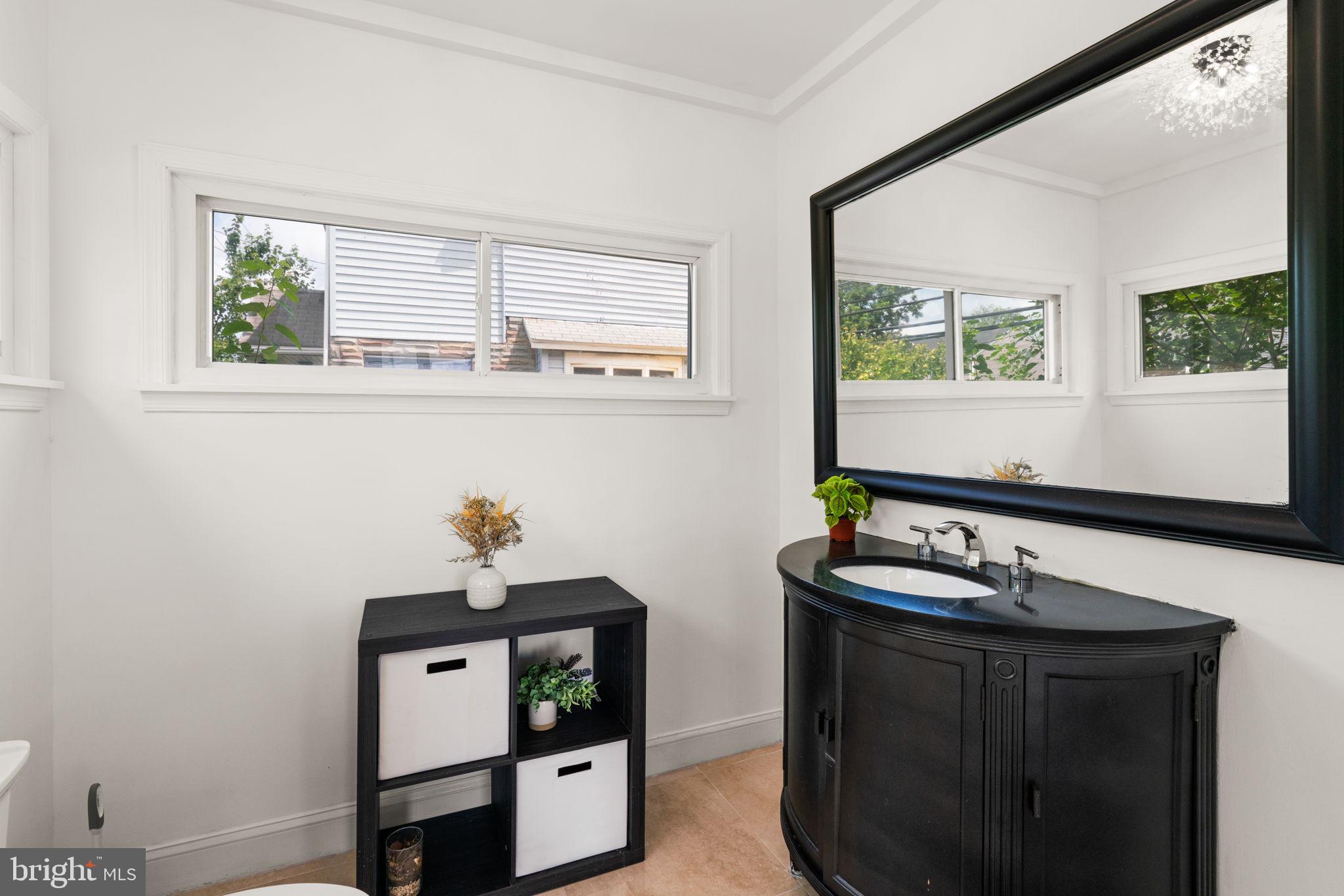 800 North Point Road Baltimore, MD 21224 - Photo 16 of 40 a bathroom with a sink and a mirror