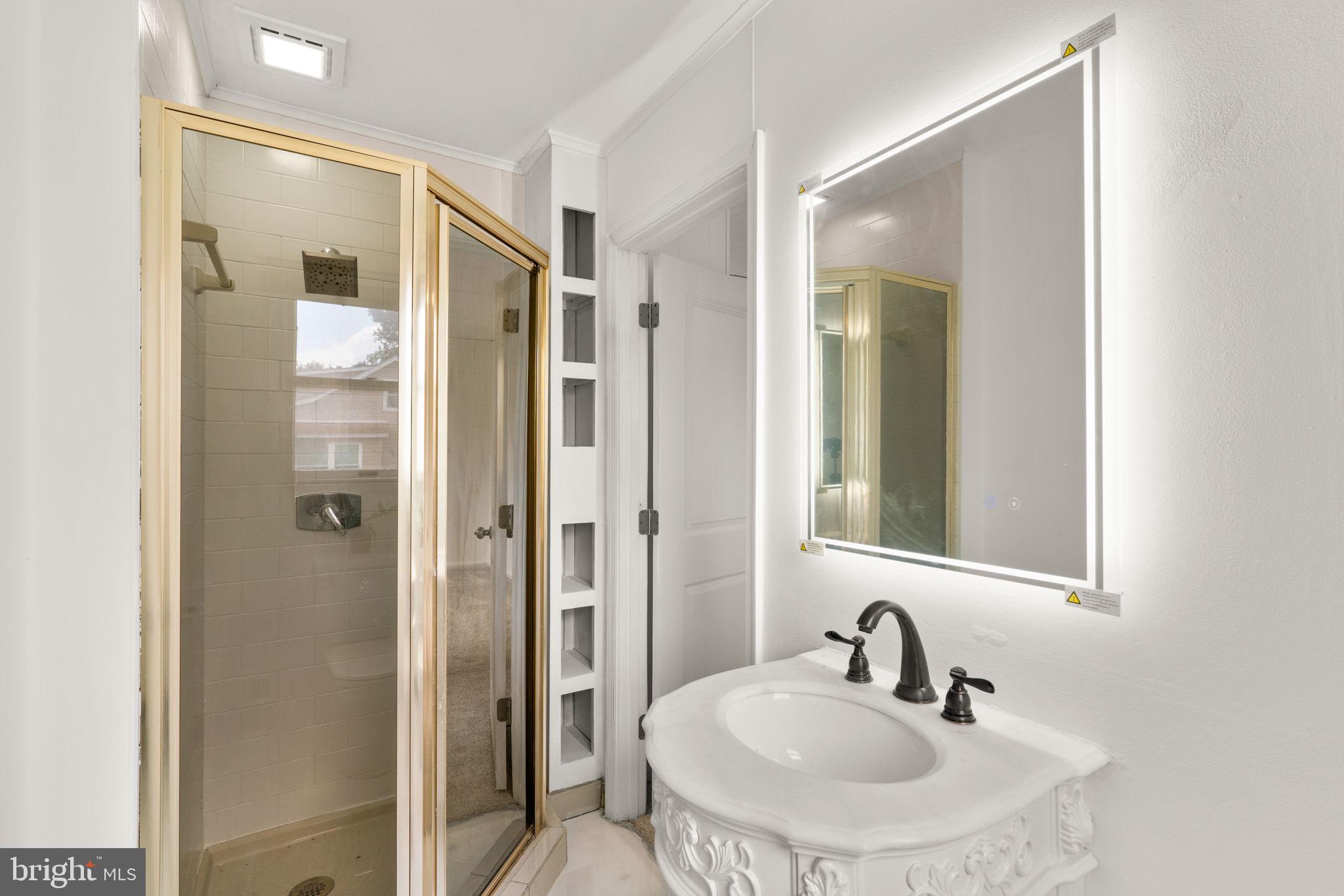 800 North Point Road Baltimore, MD 21224 - Photo 23 of 40 a bathroom with a sink and mirror