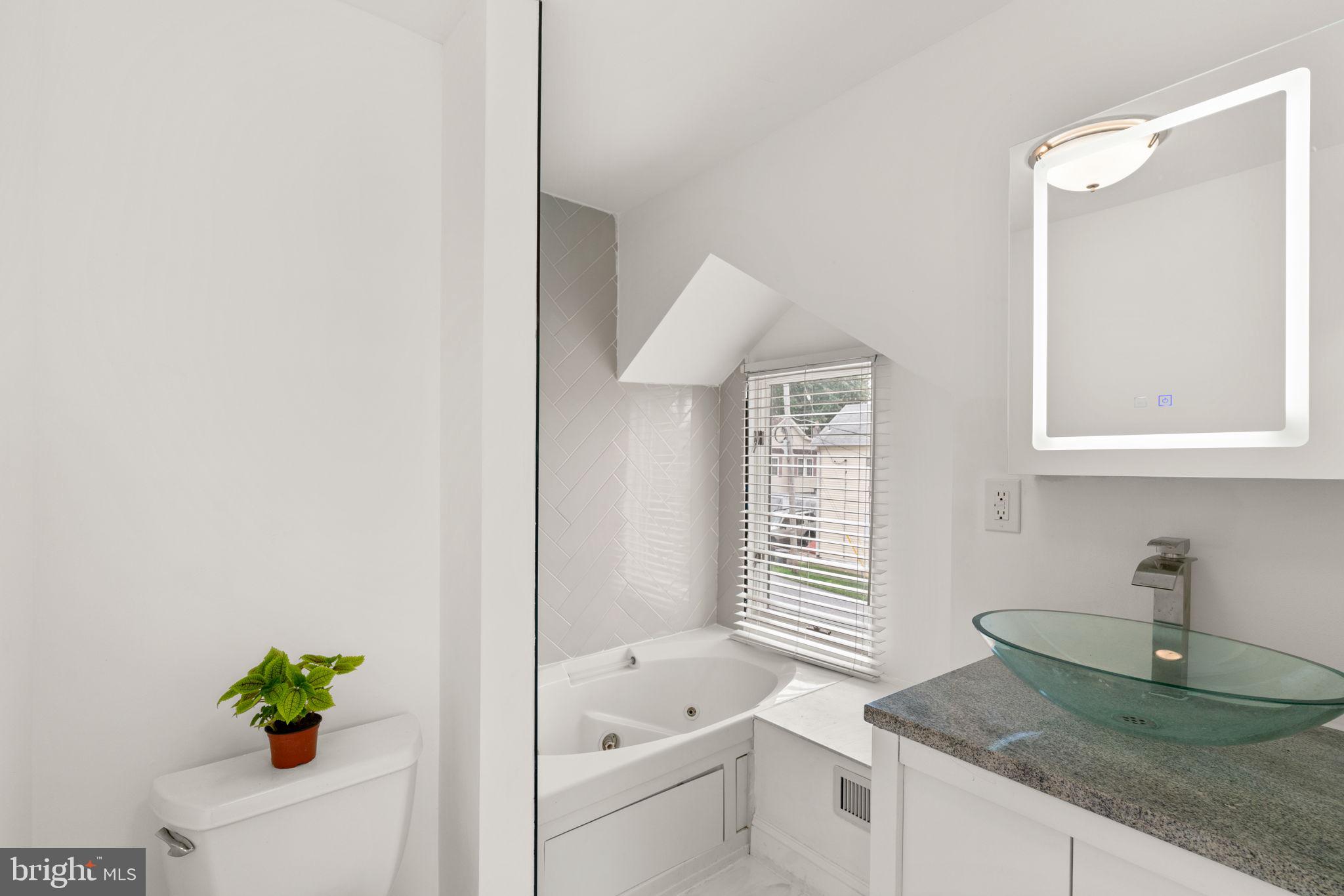 800 North Point Road Baltimore, MD 21224 - Photo 24 of 40 a bathroom with a granite countertop sink a vanity and a mirror