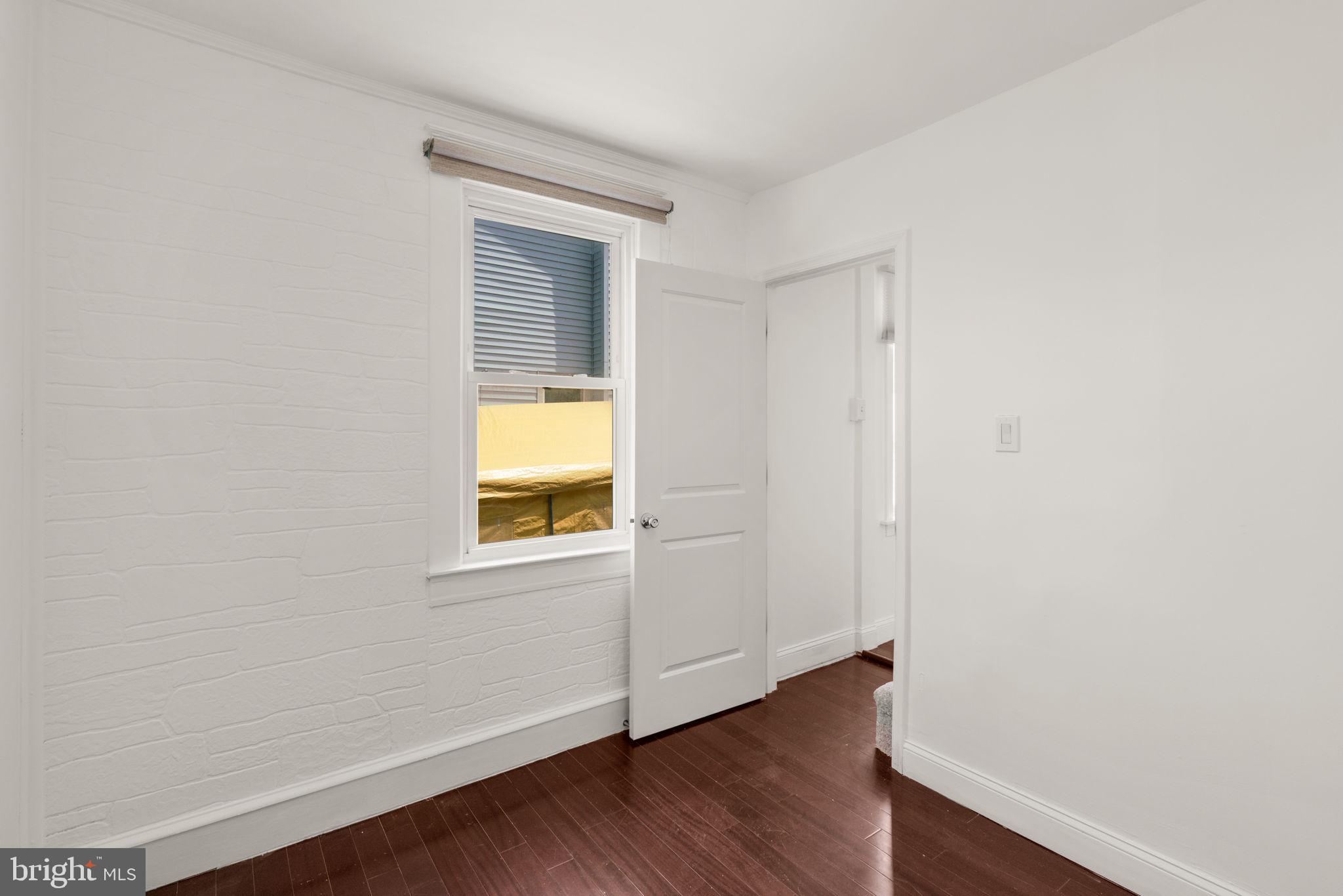 800 North Point Road Baltimore, MD 21224 - Photo 25 of 40 a view of an empty room with wooden floor and a window