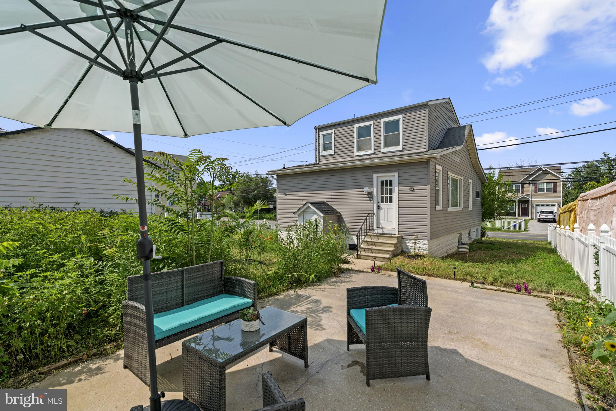 800 North Point Road Baltimore, MD 21224 - Photo 33 of 40 a patio with a table and chairs under an umbrella