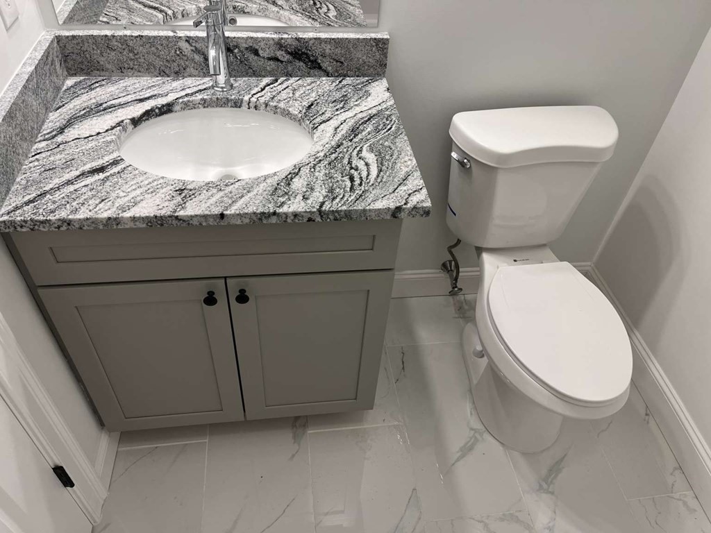 107 Putnam Hill Road Sutton, MA 01590 - Photo 12 of 21 a bathroom with a granite countertop toilet and a sink
