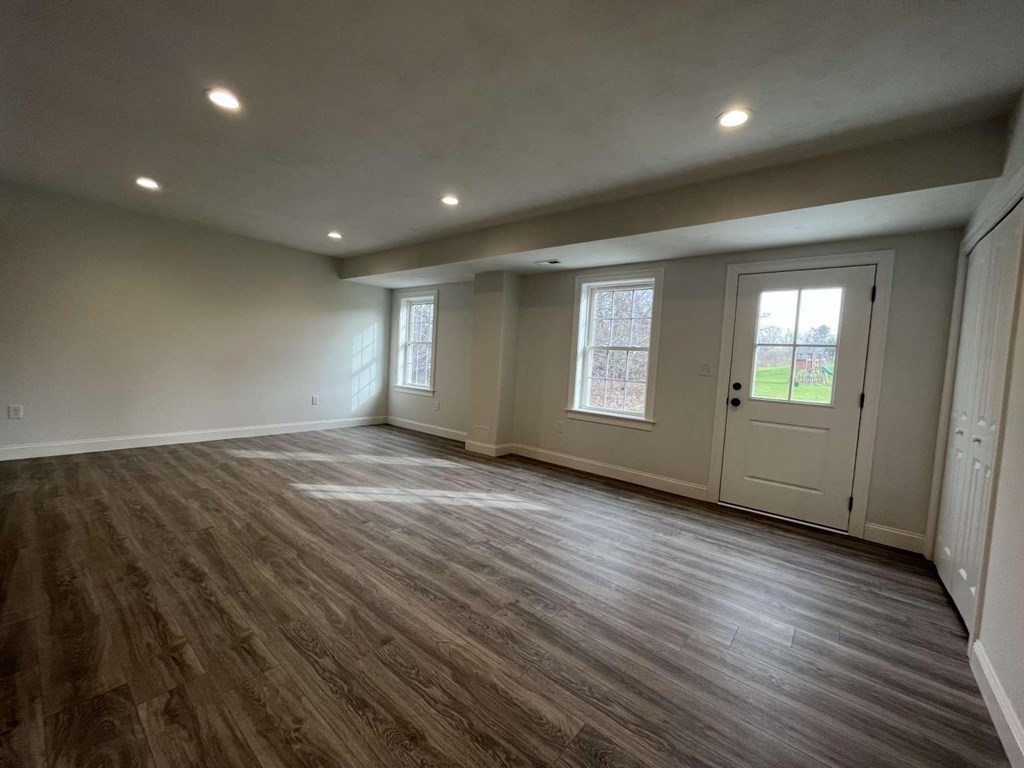 107 Putnam Hill Road Sutton, MA 01590 - Photo 15 of 21 an empty room with wooden floor and windows