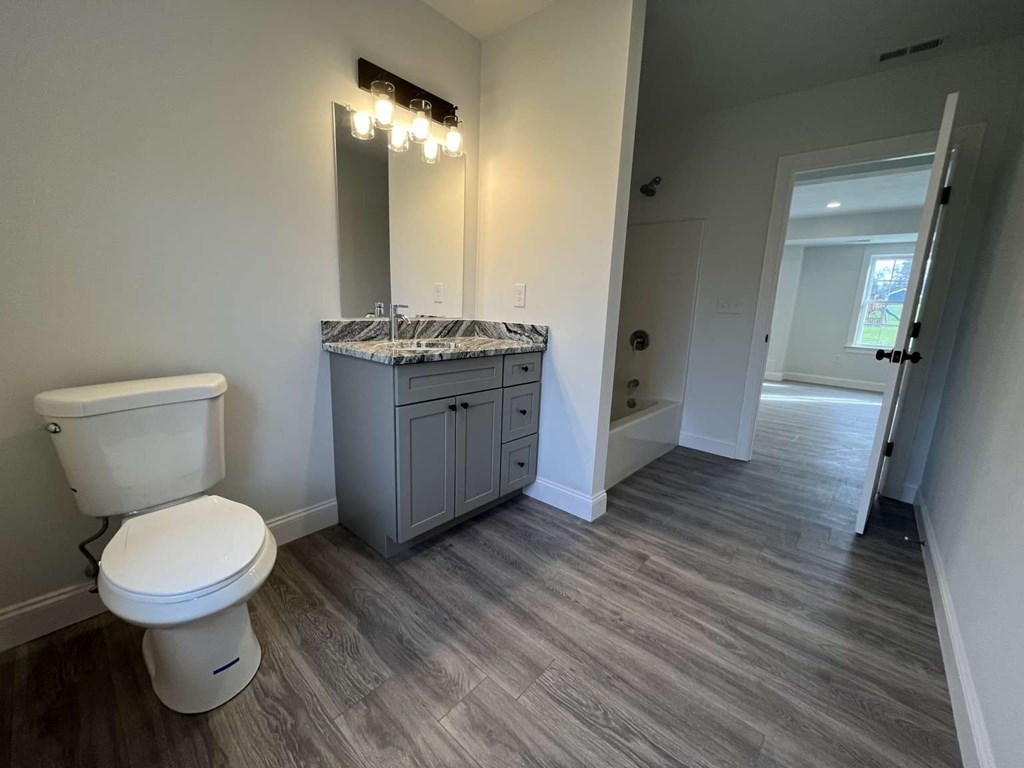 107 Putnam Hill Road Sutton, MA 01590 - Photo 17 of 21 a bathroom with a granite countertop toilet and a sink