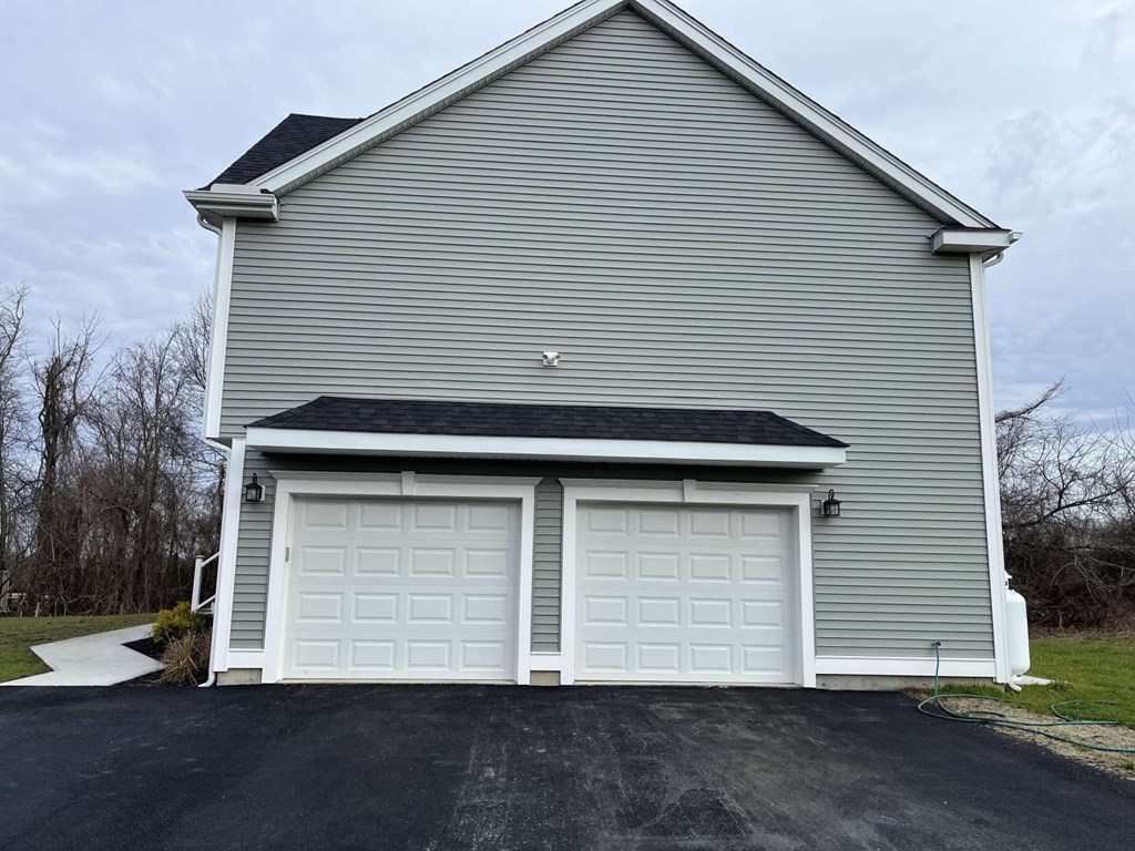 107 Putnam Hill Road Sutton, MA 01590 - Photo 19 of 21 a small white house with a white roof and a yard