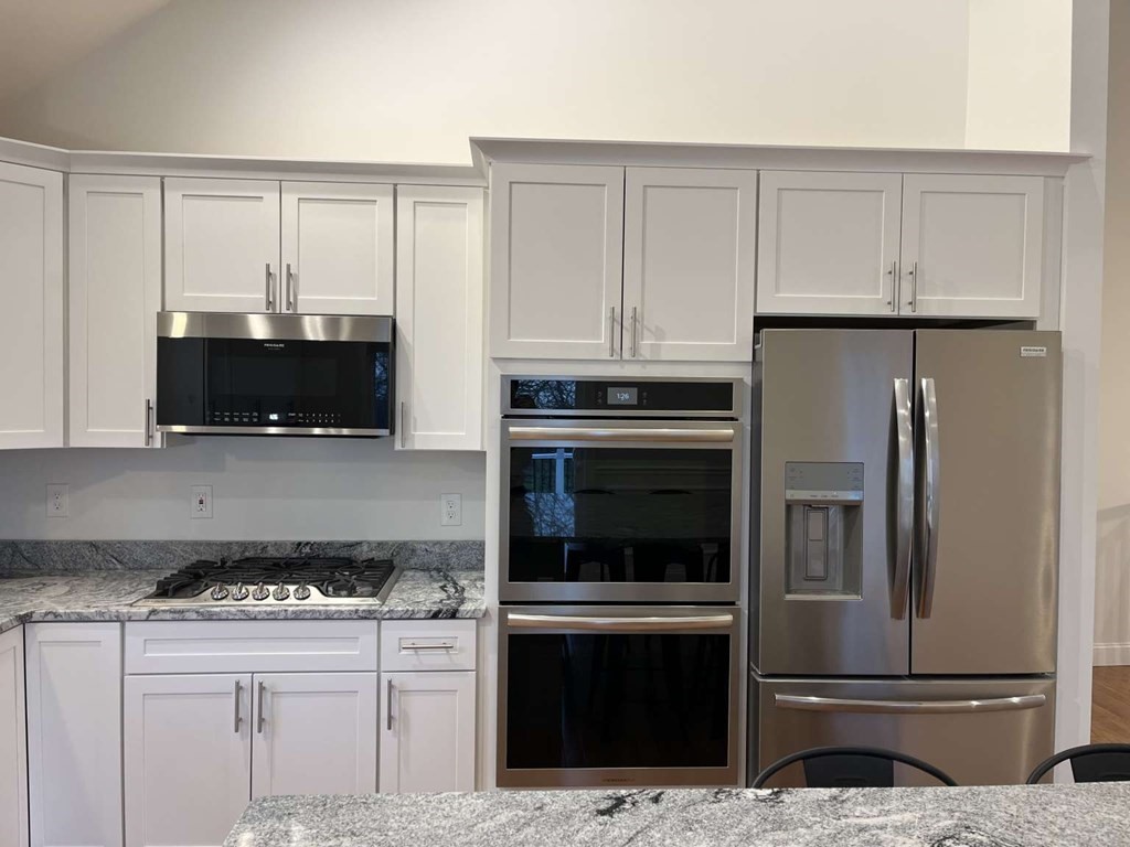 107 Putnam Hill Road Sutton, MA 01590 - Photo 5 of 21 a kitchen with granite countertop a stove and a microwave