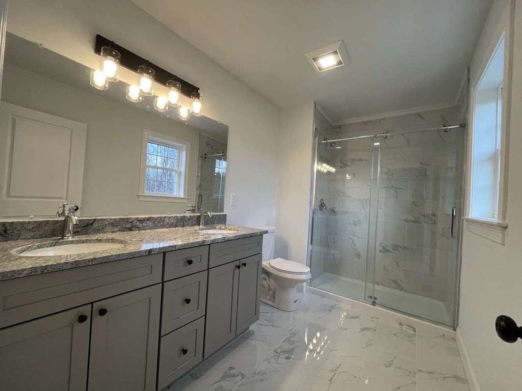 107 Putnam Hill Road Sutton, MA 01590 - Photo 7 of 21 a bathroom with a granite countertop sink mirror and toilet